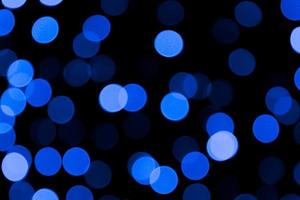 Unfocused abstract colourful bokeh black background. defocused and blurred many round blue light photo