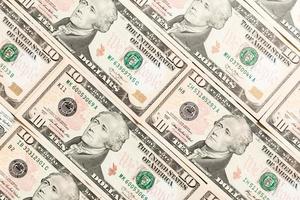 Close up of 10 dollar bills as a background. Amarican dollars pattern. Top view of business concept photo