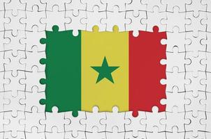 Senegal flag in frame of white puzzle pieces with missing central part photo