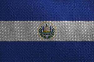 El Salvador flag depicted in paint colors on old brushed metal plate or wall closeup. Textured banner on rough background photo
