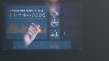 Marketer using pen pointing at graph and showing SEO concept, optimization analysis tools, search engine rankings, sites based on results analysis data,Using keywords to rank on search pages photo