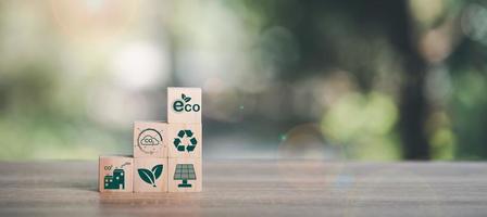 environmental protection, a sustainable renewable energy source ,clean environment ,solution of air pollution and the environment,Eco-friendly energy technology, wooden blocks placed on the table photo