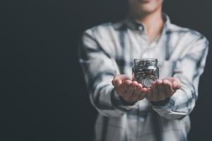 jar of coins in the hand of a man ,finance and banking, fund growth and savings concept, saving money for the future, efficient financial planning,saving for retirement,protection of your money photo