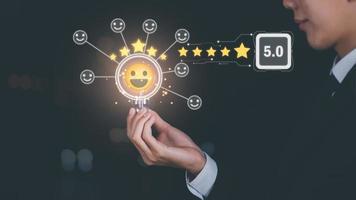 customer service and satisfaction concept,service satisfaction,very impressive rating,Evaluation and Audit,Businessman holding light bulb and 5 stars icon representing top quality in good and services photo