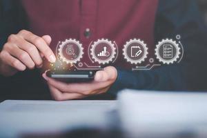Businessman audit data with smartphone, quality assessment management With a checklist, business document evaluation process, market data report analysis and consulting, plan review process. photo