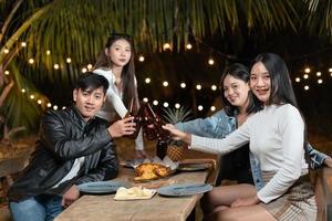 Group of friends drinking beer celebrating party in the backyard photo