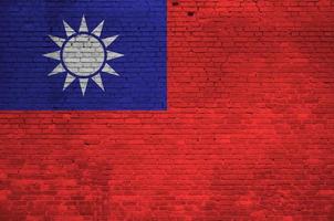 Taiwan flag depicted in paint colors on old brick wall. Textured banner on big brick wall masonry background photo