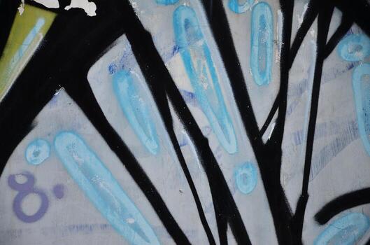 Some elements of a large and composite graffiti pattern on the wall, made with different colors of aerosol paints photo