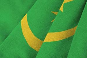 Mauritania flag with big folds waving close up under the studio light indoors. The official symbols and colors in banner photo