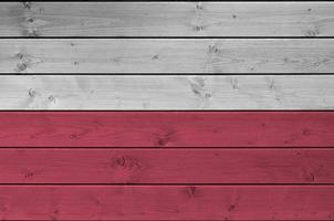 Poland flag depicted in bright paint colors on old wooden wall. Textured banner on rough background photo
