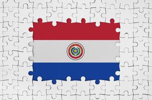 Paraguay flag in frame of white puzzle pieces with missing central part photo