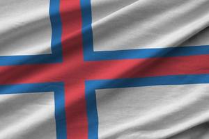 Faroe islands flag with big folds waving close up under the studio light indoors. The official symbols and colors in banner photo