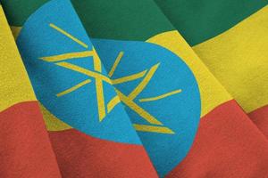 Ethiopia flag with big folds waving close up under the studio light indoors. The official symbols and colors in banner photo