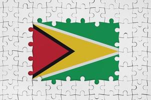 Guyana flag in frame of white puzzle pieces with missing central part photo