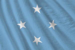 Micronesia flag with big folds waving close up under the studio light indoors. The official symbols and colors in banner photo