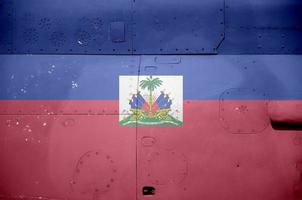 Haiti flag depicted on side part of military armored helicopter closeup. Army forces aircraft conceptual background photo