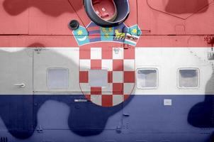 Croatia flag depicted on side part of military armored helicopter closeup. Army forces aircraft conceptual background photo