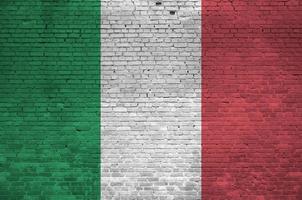 Italy flag depicted in paint colors on old brick wall. Textured banner on big brick wall masonry background photo