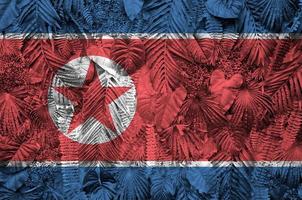 North Korea flag depicted on many leafs of monstera palm trees. Trendy fashionable backdrop photo