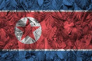 North Korea flag depicted on many leafs of monstera palm trees. Trendy fashionable backdrop photo