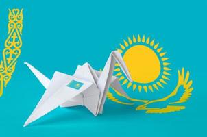 Kazakhstan flag depicted on paper origami crane wing. Handmade arts concept photo