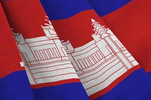 Cambodia flag with big folds waving close up under the studio light indoors. The official symbols and colors in banner photo