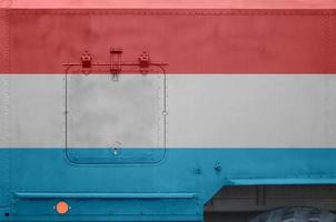 Luxembourg flag depicted on side part of military armored truck closeup. Army forces conceptual background photo