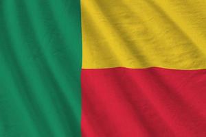 Benin flag with big folds waving close up under the studio light indoors. The official symbols and colors in banner photo