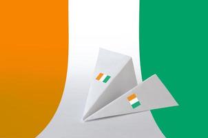 Ivory Coast flag depicted on paper origami airplane. Handmade arts concept photo