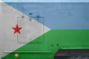 Djibouti flag depicted on side part of military armored truck closeup. Army forces conceptual background photo