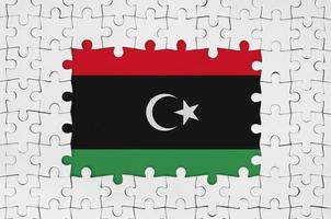 Libya flag in frame of white puzzle pieces with missing central part photo