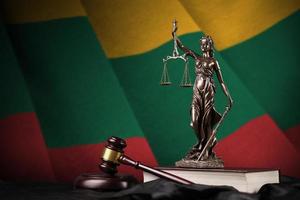 Lithuania flag with statue of lady justice, constitution and judge hammer on black drapery. Concept of judgement and guilt photo