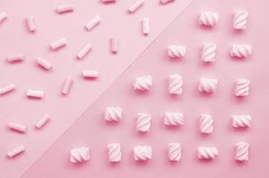 Colorful marshmallow laid out on violet and blue paper background. pastel creative textured pattern. minimal Image toned in Viva Magenta, color of the 2023 year photo