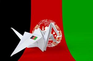 Afghanistan flag depicted on paper origami crane wing. Handmade arts concept photo