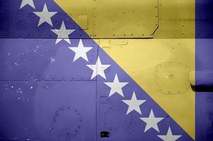 Bosnia and Herzegovina flag depicted on side part of military armored helicopter closeup. Army forces aircraft conceptual background photo