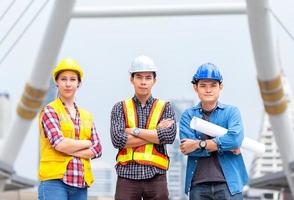 success female and male engineer discuss and manage work together with blueprint and wear safety hat at technology construction site photo