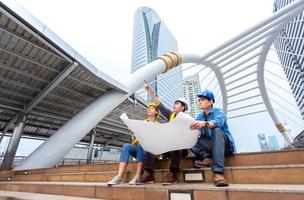 success female and male engineer discuss and manage work together with blueprint and wear safety hat at technology construction site photo