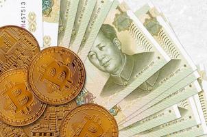 1 Chinese yuan bills and golden bitcoins. Cryptocurrency investment concept. Crypto mining or trading photo