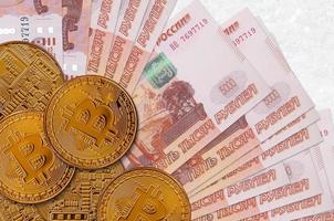 5000 russian rubles bills and golden bitcoins. Cryptocurrency investment concept. Crypto mining or trading photo