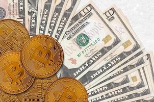 10 US dollars bills and golden bitcoins. Cryptocurrency investment concept. Crypto mining or trading