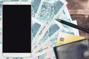 100 Czech korun bills and smartphone with purse and credit card. E-payments or e-commerce concept. Online shopping and business with portable devices photo
