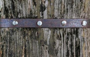 Texture brown wood background with pin and metal rusty cover photo