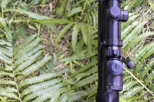 Top view rifle on grass floor photo