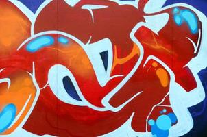 Fragment of graffiti drawings. The old wall decorated with paint stains in the style of street art culture. Colored background texture photo