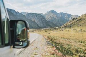 Parked car on auto road against beautiful mountain landscape, Chemalsky tract, Altai photo