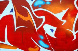 Fragment of graffiti drawings. The old wall decorated with paint stains in the style of street art culture. Colored background texture photo
