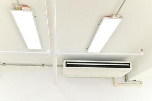 Air conditioner on brown wall room interior background photo
