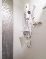 Loft white tile bathroom corner, tub and sink photo