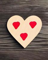 Red Love Heart Shaped Sticker on Wooden Table photo