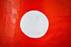 Red background and white circle on center paint on red wall photo